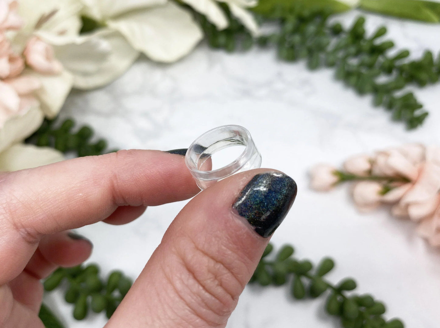 Small plastic sphere stands from Contempo Crystals Shop for holding crystal spheres.