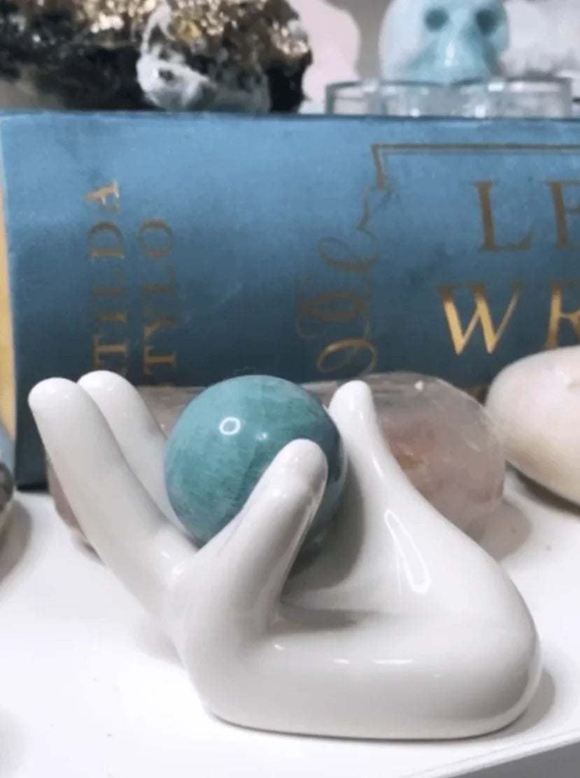 Ceramic Hand Sphere Holder. Holding a small sphere