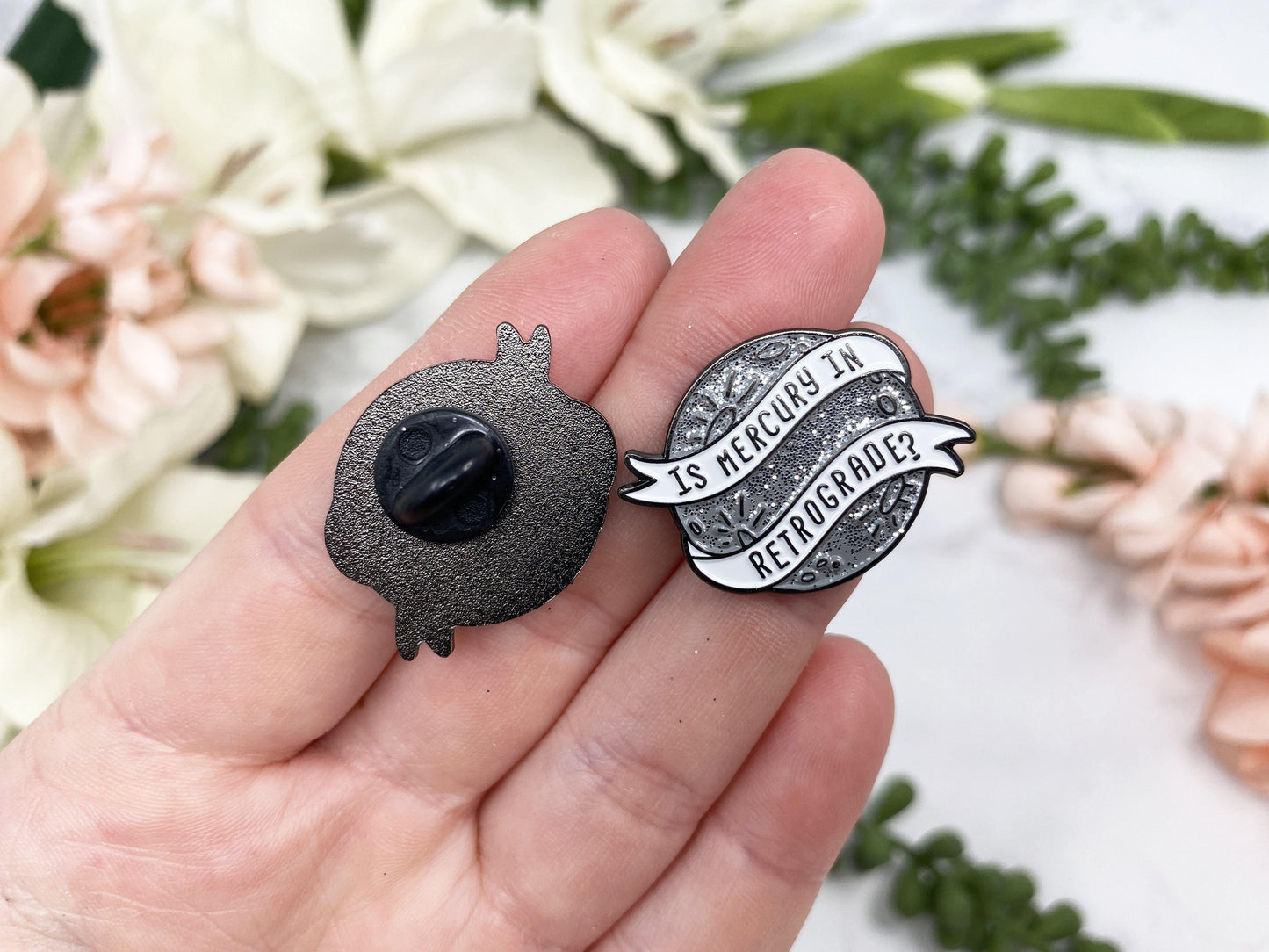 Silver Sparkle Mercury Retrograde Lapel Pin. Rubber closure.