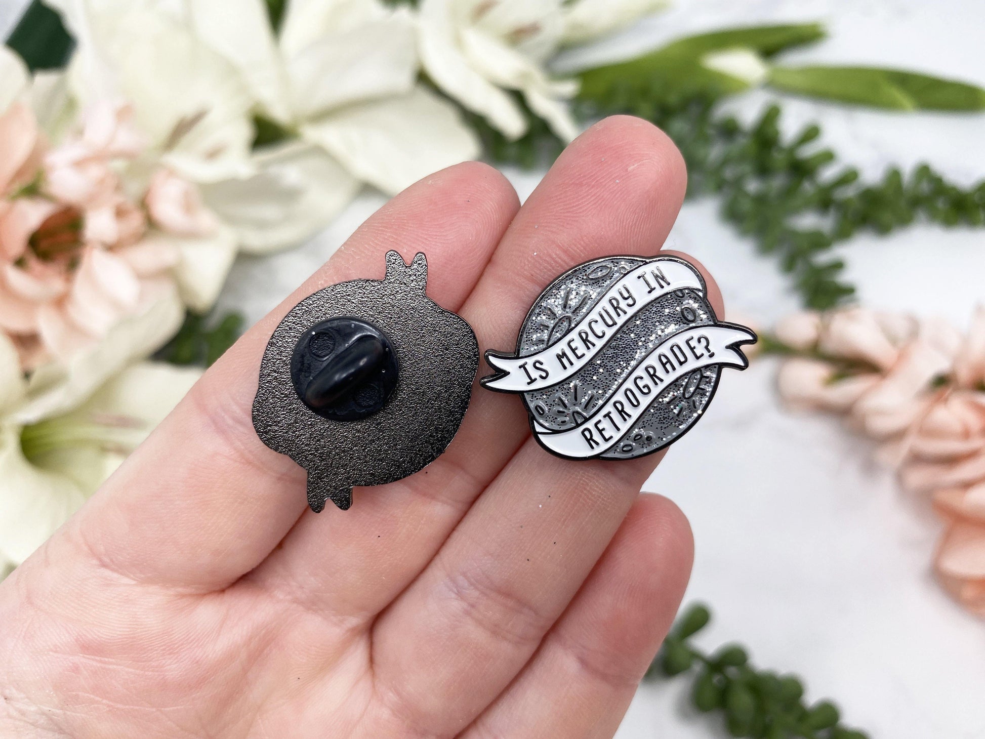 Silver Sparkle Mercury Retrograde Lapel Pin. Rubber closure.