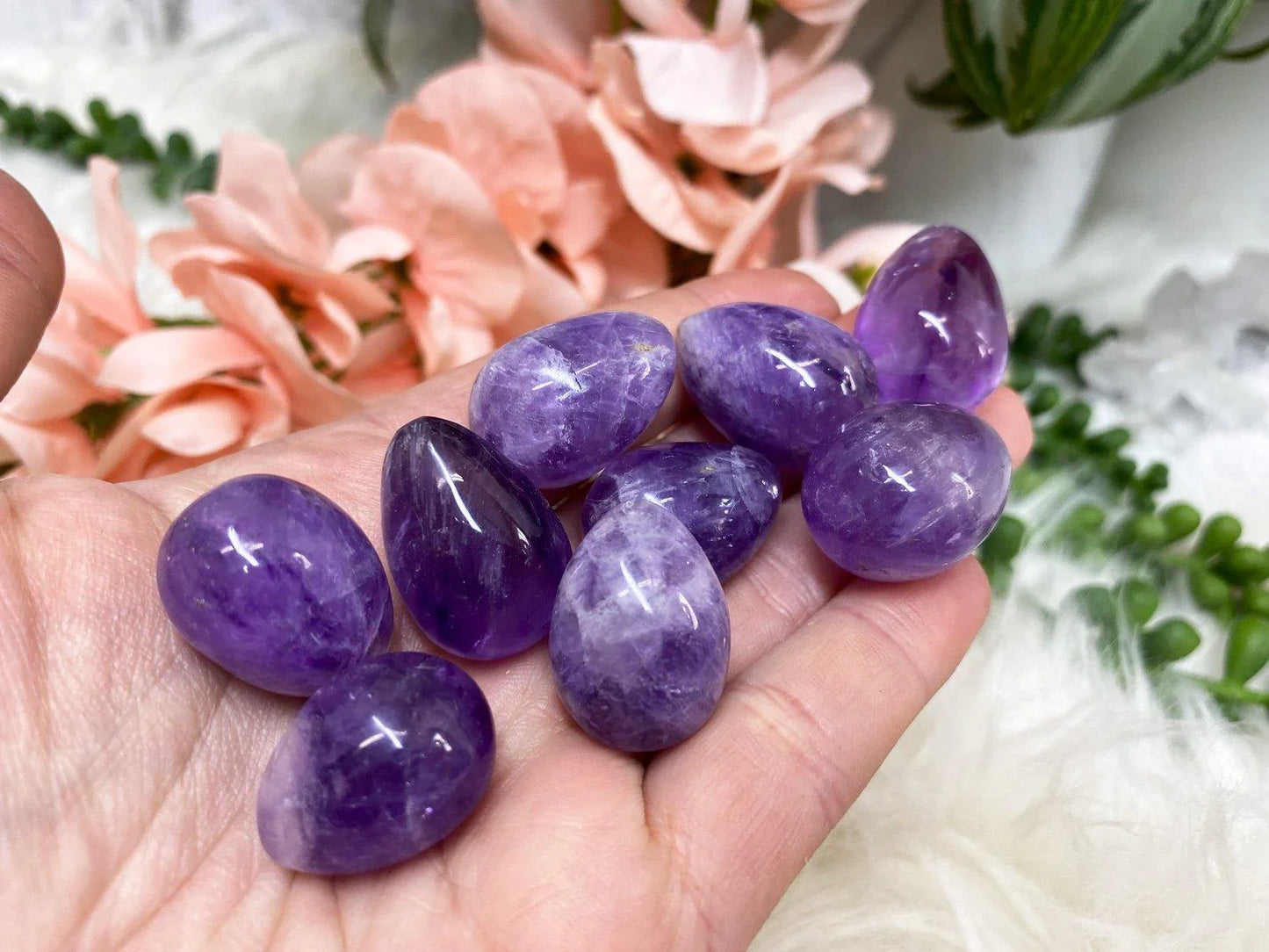 Small amethyst crystal egg in hand