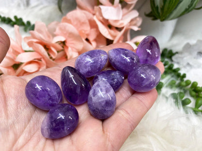 Small amethyst crystal egg in hand