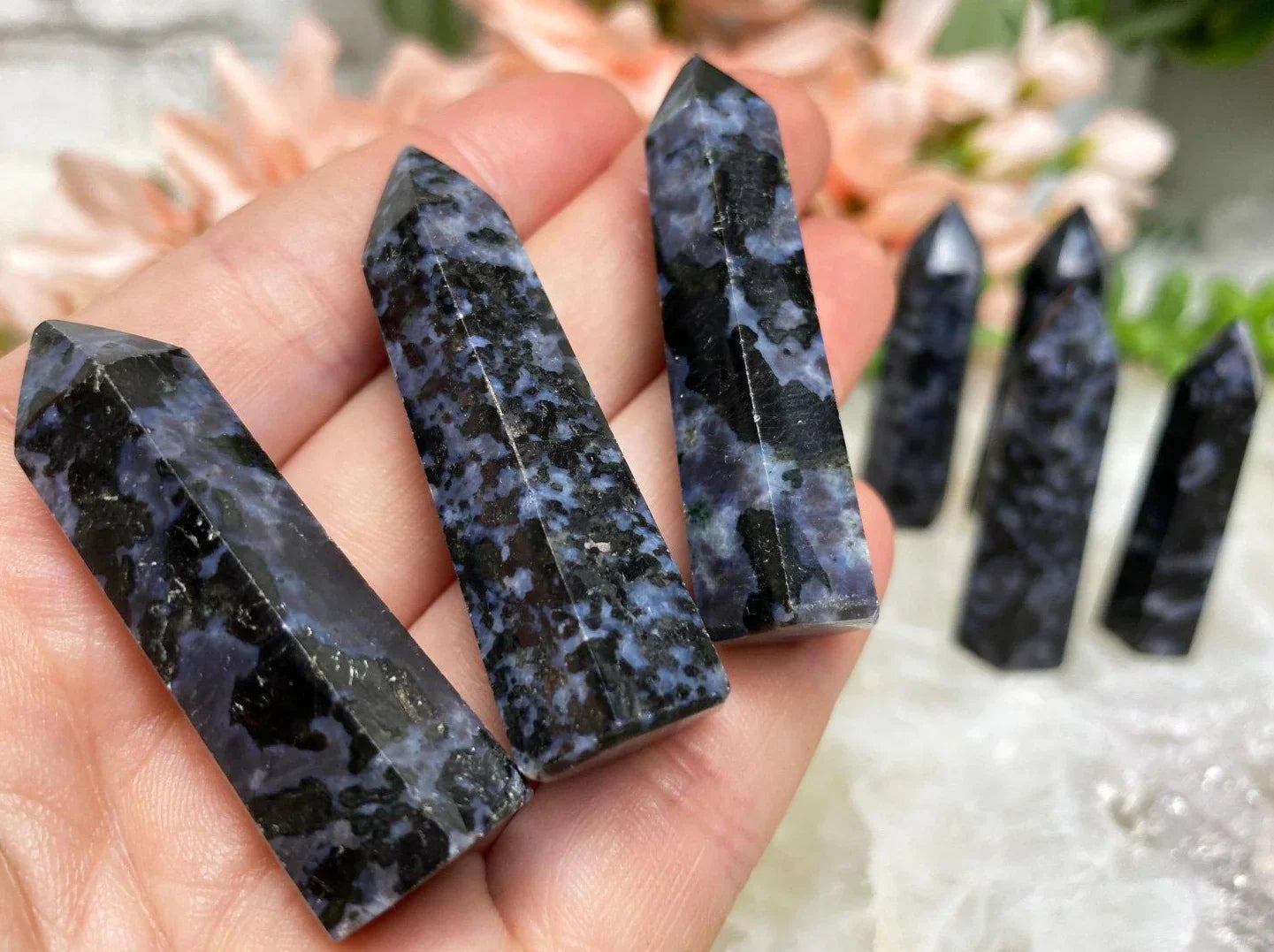 Small indigo gabbro crystal points in hand